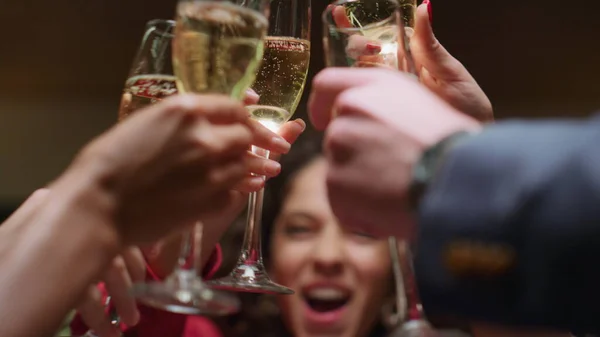 Beautiful woman drinking alcohol with friends group on restaurant celebration. Close up people hands clinking drink glasses in bar. African american girl enjoy friends meeting in cafe. Party concept.