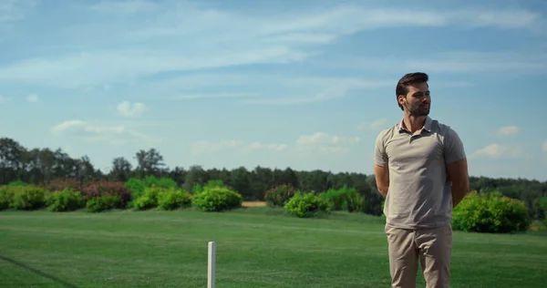 Golf players group chatting together at fairway course. Golfers team driving cart outdoors. Smiling husband wife discussing golfing game tournament on sunny summer day. Wealthy lifestyle hobby concept