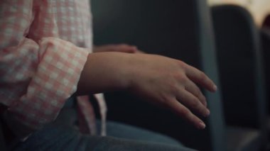 Tanınmayan ergen el kol hareketleri yaparak arkadaşlarıyla konuşuyor. Okul otobüsündeki kız avuçlarını kapat. Okul servisi koltuğunda şık kıyafetler giyen genç bir çocuk. Kamu eğitim ulaşımı. Vücut dili