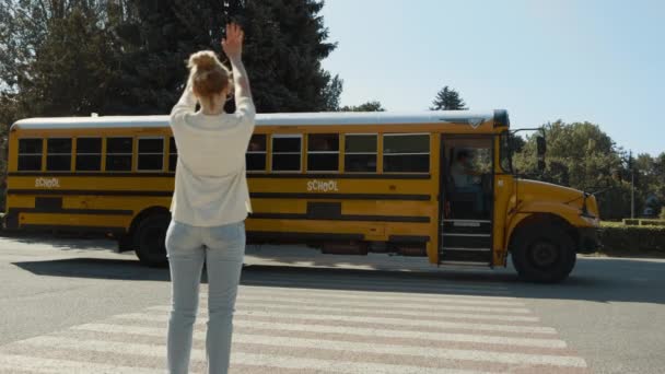 Szczęśliwa Mama Stoi Machając Dziecka Siedząc Żółty Autobus Szkolny Radosna — Wideo stockowe