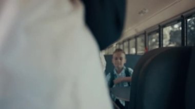 Grup halinde çeşitli öğrenciler okul otobüslerinde oturuyorlar. Mutlu gençler toplu taşıma koltuklarına oturuyorlar. Sırt çantalı ilkokul çocukları arkadaşlarıyla buluşuyor. Eğitim kavramı.