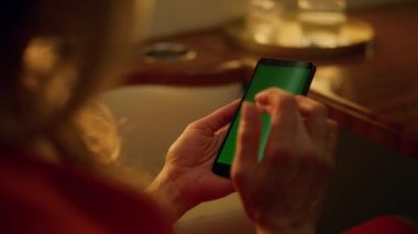 Şirket gezisinde yeşil akıllı telefon kullanan bir kadın. El yazması maket ekranı. Lüks bir kulübede e-posta sosyal medyasını kontrol eden tanınmamış zengin bir iş kadını. Kablosuz teknoloji kavramı.