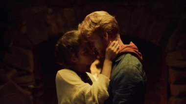 Dansçı aşıklar romantik bir gece şöminesi kullanırlar. Şehvetli çift, kışlık evde aşk dansına sarılıyor. Sevimli erkek arkadaş geceleri sarılmaktan hoşlanıyor. Evlilik hayatı konsepti.