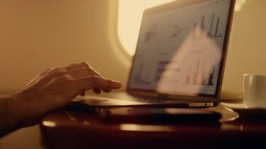 Bilgisayardaki dokunmatik dokunmatik eller. Yönetici uçak penceresinde bilgisayar grafikleri üzerinde çalışıyor. Bilinmeyen bir işadamı, uçaklarda bilgisayar izleme sistemi kullanıyor. Ekranda iş diyagramları.