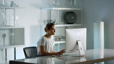 Successful lady writing email. Interior designer working on computer in office. Beautiful manager therapist communicating chatting client online. Corporate consultant preparing financial presentation.