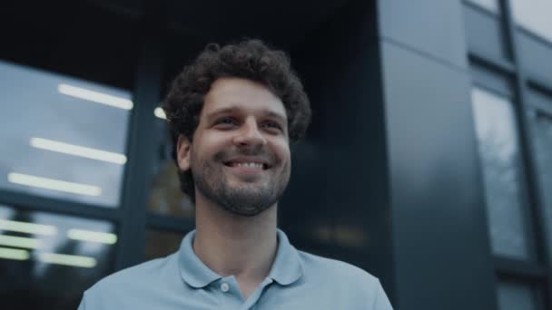 Portrait Happy Smiling Man Posing Modern Building Cheerful Curly Haired — Stockvideo