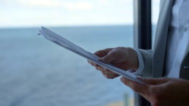 İş adamı sözleşmenin detaylarını okyanus manzarasına işaret ediyor. Kapalı eller kağıtları tutar. Tanımlanamayan kızgın müşteri yatırımcısı belge bilgilerini tartışıyor. Ciddi patron yasal mali rapor hatalarını kontrol et