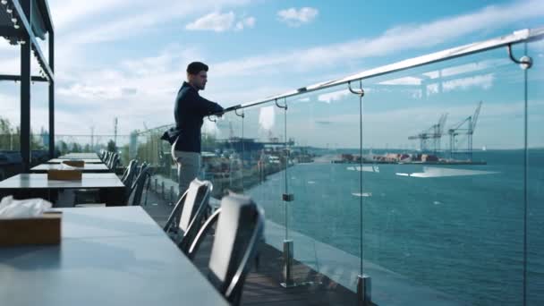 Millennial Guy Resting Terrace Sea Port View Freelancer Enjoying Ocean — Stockvideo