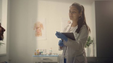 Hastane ofisinde tablet kullanan bir kadın doktor hastayı test ediyor. Modern klinikte yaşlı bir adama danışmanlık yapan çok ırklı bir doktor. Coronavirüs dönemi konseptinde sağlık hizmetleri.