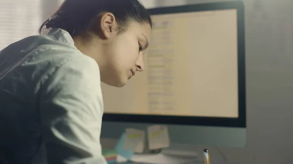 Woman therapist making medical journal entries at modern hospital workplace close up. Mixed race lady doctor writing notes general examination elderly patient. Medic working in clinic sitting desk.