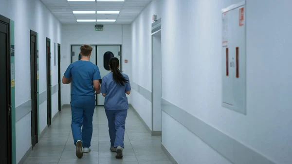 Doctors Colleagues Walking Clinic Corridor Talking Work Back View Two — Fotografia de Stock