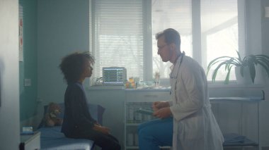 Afrikalı genç kız hastane ofisinde oturan doktoru ziyaret ediyor. Tıbbi konsültasyonda reşit olmayan bir hastayla konuşan profesyonel bir çocuk doktoru. Pozitif doktor sağlık şikâyetleri soruyor genç çocuk..