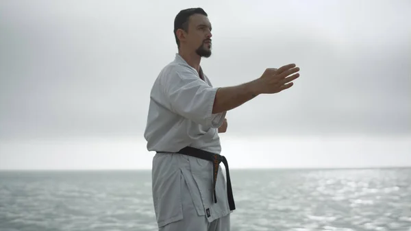 Confident Man Practicing Hands Position Doing Karate Calm Sea Bearded — 스톡 사진