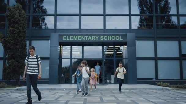 Diverse Pupils Leaving Elementary School Building Happy Children Talking Smiling — ストック動画