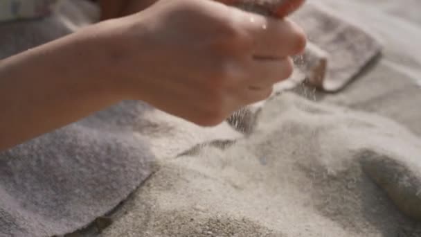 Smiling Curly Woman Pouring Sand Fingers Lying Beach Close Happy — 图库视频影像