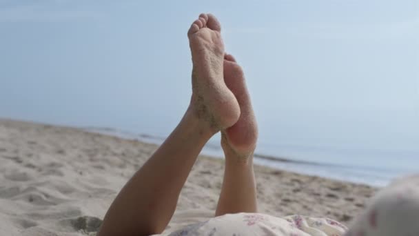 Cute Happy Girl Raised Legs Sand Lying Beach Summer Day — Vídeos de Stock