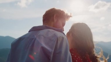 Cheerful family relax nature mountains on holiday. Closeup couple enjoy landscape view outdoors back view. Romantic hipsters lovers rest outside. Happy millennials spend summer vacation. Love concept.