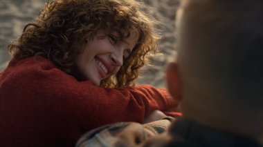 Gülümseyen kadın ve adam sahilde çıkıyorlar. Deniz kıyısında flört eden mutlu çift. Sevgi dolu bir adama gülümseyen kızın portresi. Dudaklarını ısıran seksi bayan. Sevgililer birlikte vakit geçiriyorlar. Duygular konsepti