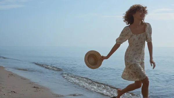 Slim Happy Girl Running Ocean Water Holding Straw Hat Summer — Zdjęcie stockowe