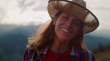 Closeup attractive traveler face smiling on nature view. Portrait of young woman enjoy summer weekend. Beautiful girl look camera outside. Relaxed model posing on travel hike. Natural happy concept.