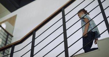 Okul binasına giden merdivenlerden inen aktif çocuk. Dersten sonra alt kata inen ilkokul çocuğu. Örgülü merdivenlerden tek başına atlayan enerjik bir öğrenci. Ergen çocuk tatilde iyi eğlenceler..