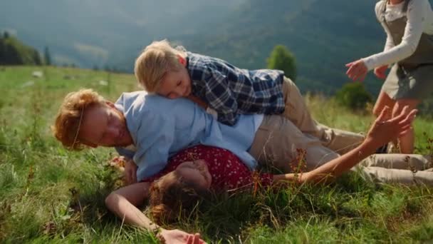 Playful Family Piled Each Other Lying Green Grass Mountain Hill — Stockvideo