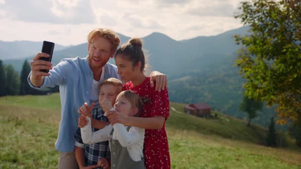 Joyful Family Taking Selfie Sticking Tongues Using Cellphone Green Hill — Stockvideo