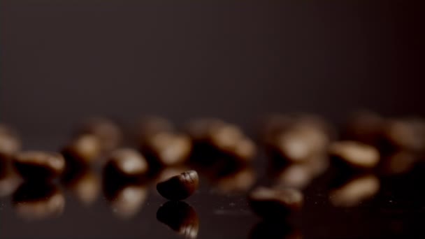 Closeup Few Coffee Beans Lying Table Super Slow Motion One — Vídeo de Stock