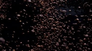 Tasty coffee seeds fall on camera close up super slow motion. Fragrant fresh beans for energetic drink flying on black background. Roasted brown grains splashing. Beautiful cafe design concept.