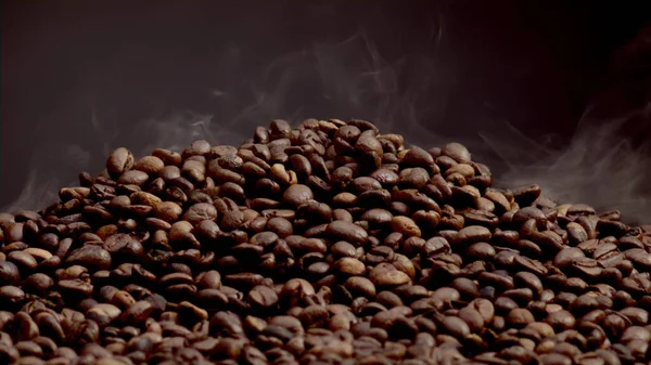 Fragrant smoke coming from roasted coffee beans close up. Light steam rising over heap seeds in super slow motion. Fresh brown grains for morning energy beverage. Great aroma of coffee concept.