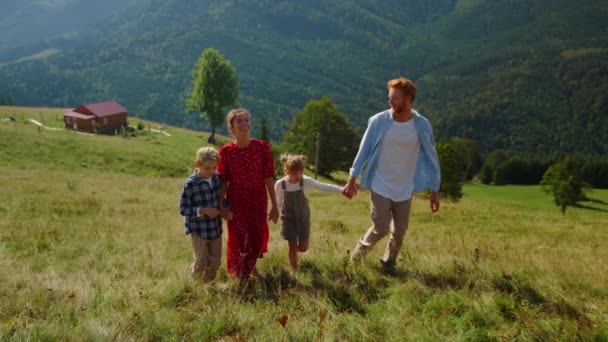 Positive Family Stepping Green Grass Walk Top Green Slope Sunny — Vídeos de Stock