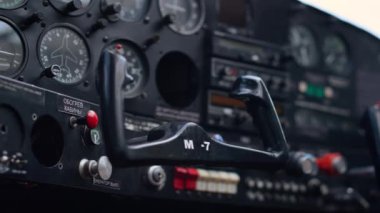 Modern airplane steering wheel inside small private aircraft cockpit close up. Technical control panel with buttons indicators in ultralight personal plane. Engineering aviation transport concept.