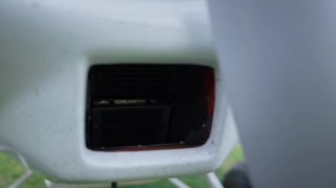 Closeup small airplane part of engine under white propeller. Important technical detail ultralight private plane working before flying from runway airfield. Technical maintaining aviation concept.