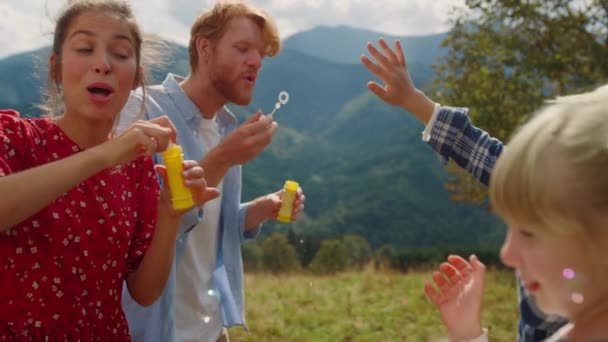 Cheerful Family Enjoy Blowing Soap Bubbles Outdoor Catching Children Close — Vídeo de Stock