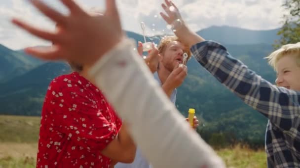 Happy Family Playing Blowing Soap Bubbles Summer Mountains Closeup Joyful — Vídeo de Stock