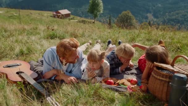 Young Parents Enjoy Picnic Cute Children Lying Green Grass Mountain – Stock-video