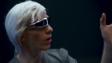 Amazed VR helmet man expressing wow reaction. Surprised gamer touching invisible objects closeup. Excited guy emotions after new augmented reality experience. Metaverse and virtual world adventures 