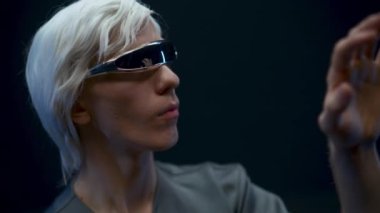 Vr goggles man analyzing innovation data with cyberspace. Blonde guy glasses taking new experience in virtual world. Global Internet connection and futuristic technology of metaverse concept 