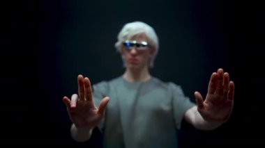 Man using invisible touchscreen closeup. Blonde guy checking data swipe digital futuristic emails collecting info. High-tech work process metaverse. Person in virtual reality glasses black background