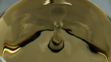 White wine drop goblet closeup. Alcohol beverage droplet fall splashing smooth surface top view. Cool golden chardonnay grape drink waving rippling in glass. Calm romantic evening relaxation concept.