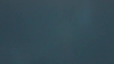 Closeup blender crushing ice in container. Barkeeper machine grinding cubes. Making cool iced summer cocktail in mixer bowl. Frozen chunks splitting into pieces. Kitchen household equipment concept.