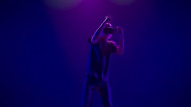 Skilled man playing immersive virtual reality game alone. VR goggles guy gaming fighting using controllers slow motion. Blonde person enjoying 3D technology. People and technology metaverse concept 