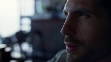 Businessman portrait thinking alone closeup. Upset ceo man director pondering about work problem at office. Focused independent business owner looking distance in dark hotel. Sad person concept