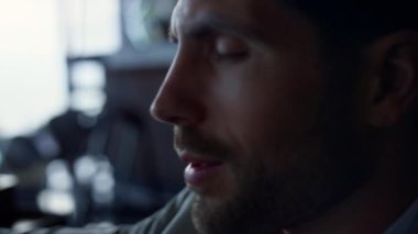 Unshaven businessman reading message closeup. Stressed boss director portrait holding smartphone in dark luxury hotel. Sad male professional getting bad news with cellphone. Work problems concept