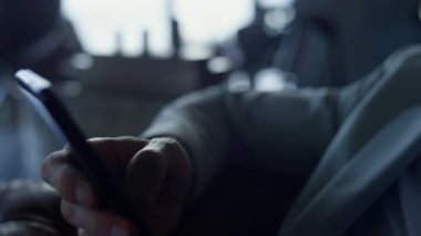 Serious man looking mobile phone in private house portrait. Tired businessman watching smartphone in dark luxury hotel. Worried manager hands holding device waiting office closeup. Depression concept