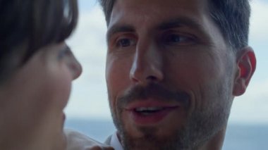 Marriage couple looking each other portrait. Closeup smiling people talking laughing at panoramic window hotel. Romantic family spending time together at terrace. Love partners relationship concept 