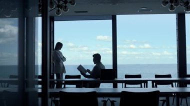 Office secretary showing businessman documents at panorama window. Unknown elegant woman assisting boss leaving room. Unrecognized professional checking analyzing financial report at sea marina view 