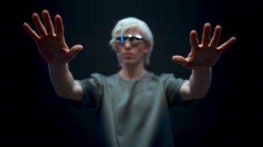 Man working inside metaverse in virtual reality world. Creative male in headset looking hands touching invisible objects. Person vr goggles experience futuristic social media concepts slow motion