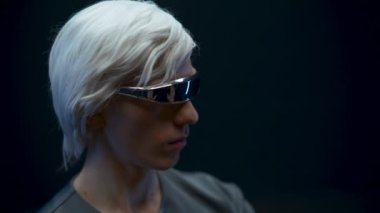 Blonde gamer playing metaverse nft in 3d glasses closeup. Smart man typing surrounded with futuristic invisible interface 3d data black background. Augmented reality, future technology concept