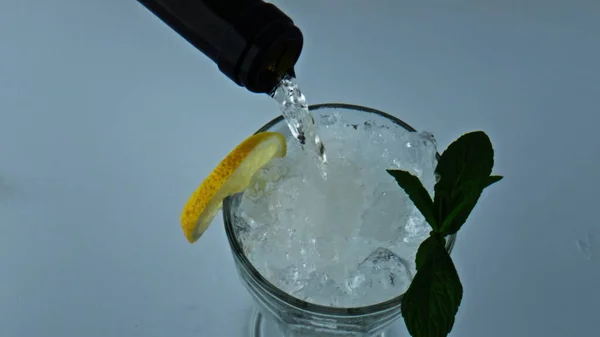 Bottle Pouring Liquid Cocktail Closeup Refreshing Iced Lemon Mint Beverage — Stok Foto